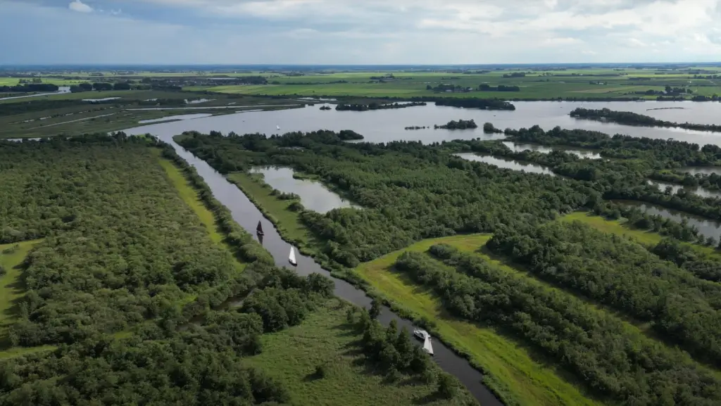 A drone shot of Fryslân - lots of forests, lakes and canals.